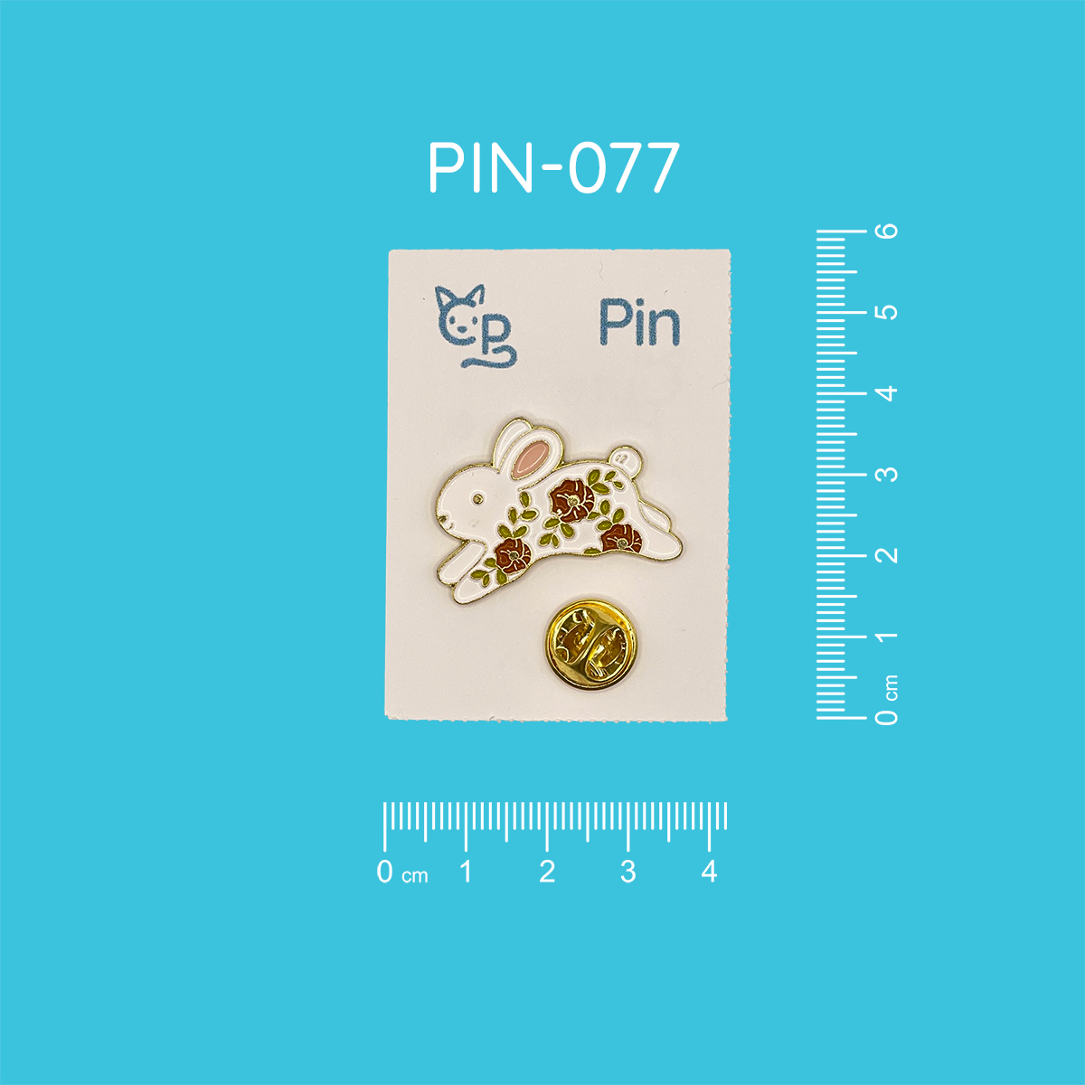 Pin mit dem Motiv eines springenden weißen Hasen, dessen Fell mit roten Blumen und grünen Blätterranken geziert ist.