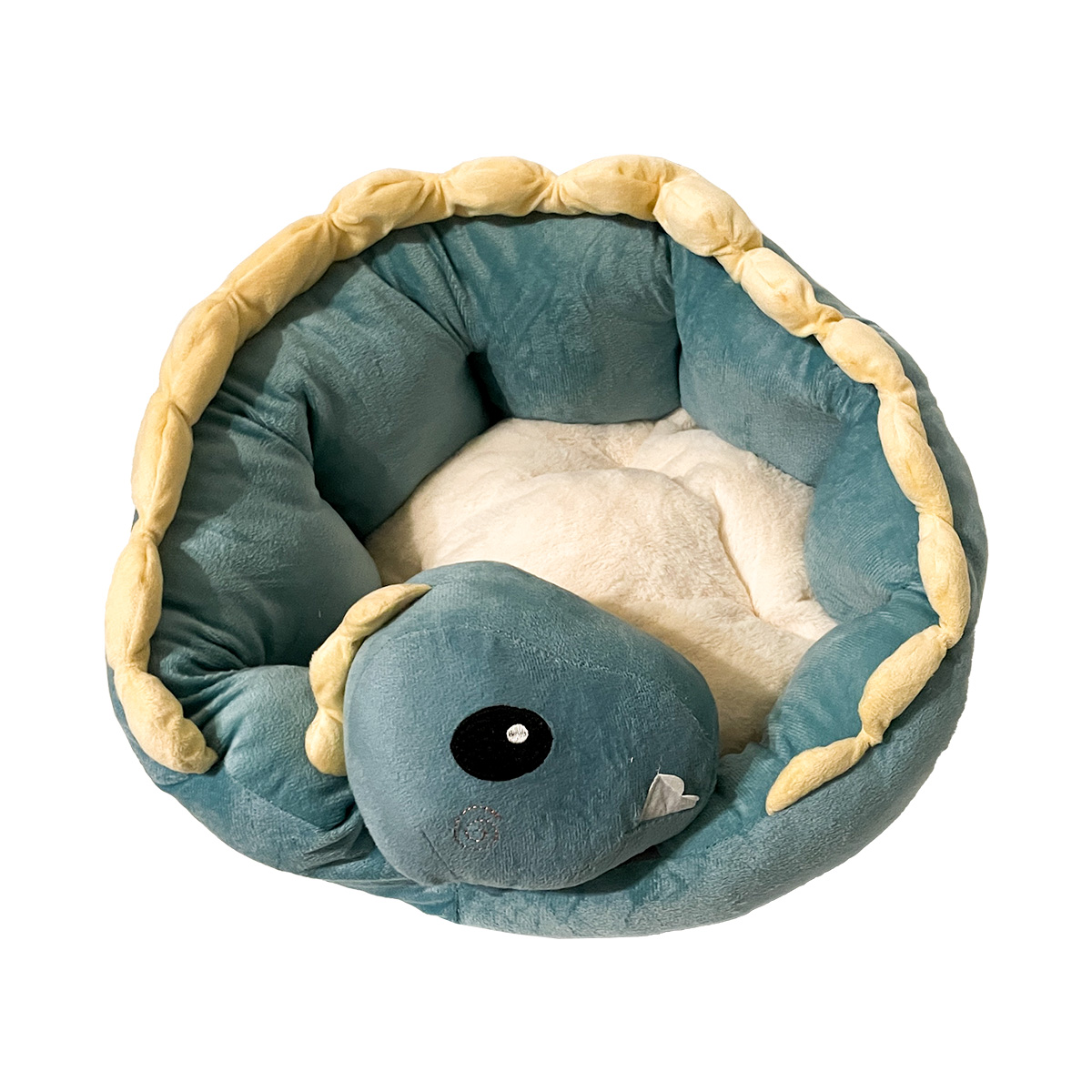 Bett_D-k Rundes Haustierbett in den Farben beige, gelb und grün, welches die Form eines Drachen hat, dessen Kopf auf seinem eigenen Schwanz abgelegt ist. In der Mitte ist der Platz zum Schlafen für das Haustier.
